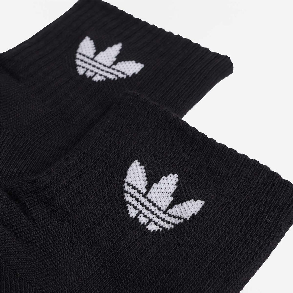 White Adidas trefoil logo on black ribbed sock