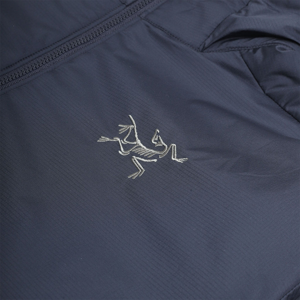 Embroidered Arc'teryx bird logo on navy chest