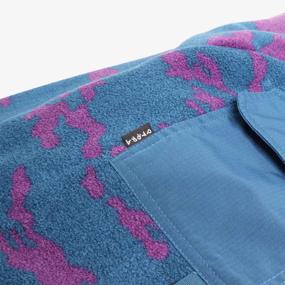 Zipped pocket detail on blue and purple camo fleece