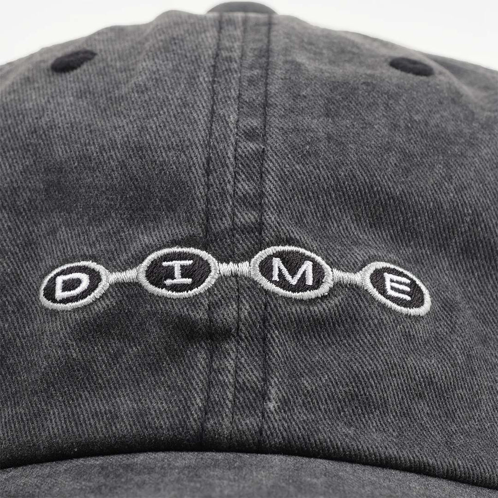 Embroidered Dime beaded logo on washed black cap front