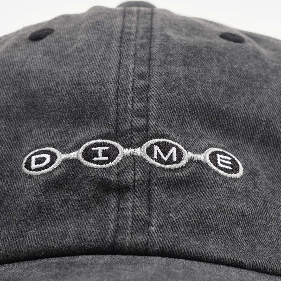 Embroidered Dime beaded logo on washed black cap front