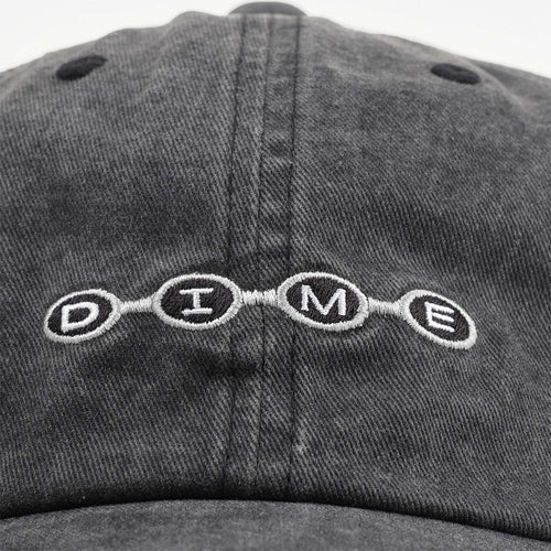 Embroidered Dime beaded logo on washed black cap front