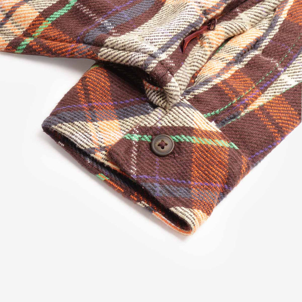 Buttoned cuff detail on rust check flannel