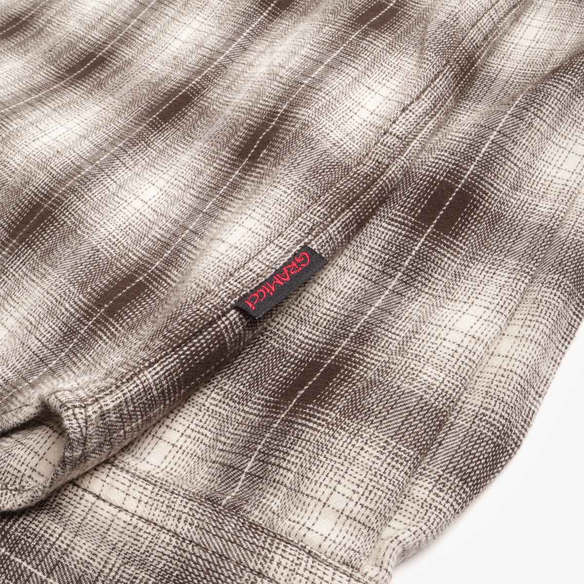 Red Gramicci hem tab on slate plaid flannel