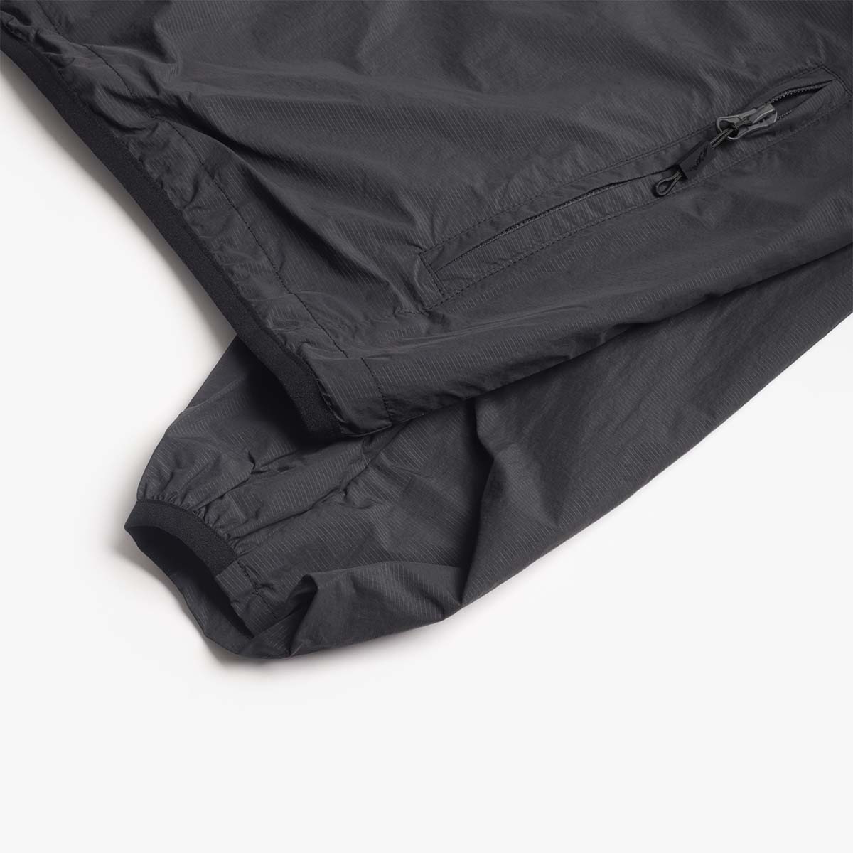 Zipped sleeve pocket detail on the black Boulder jacket