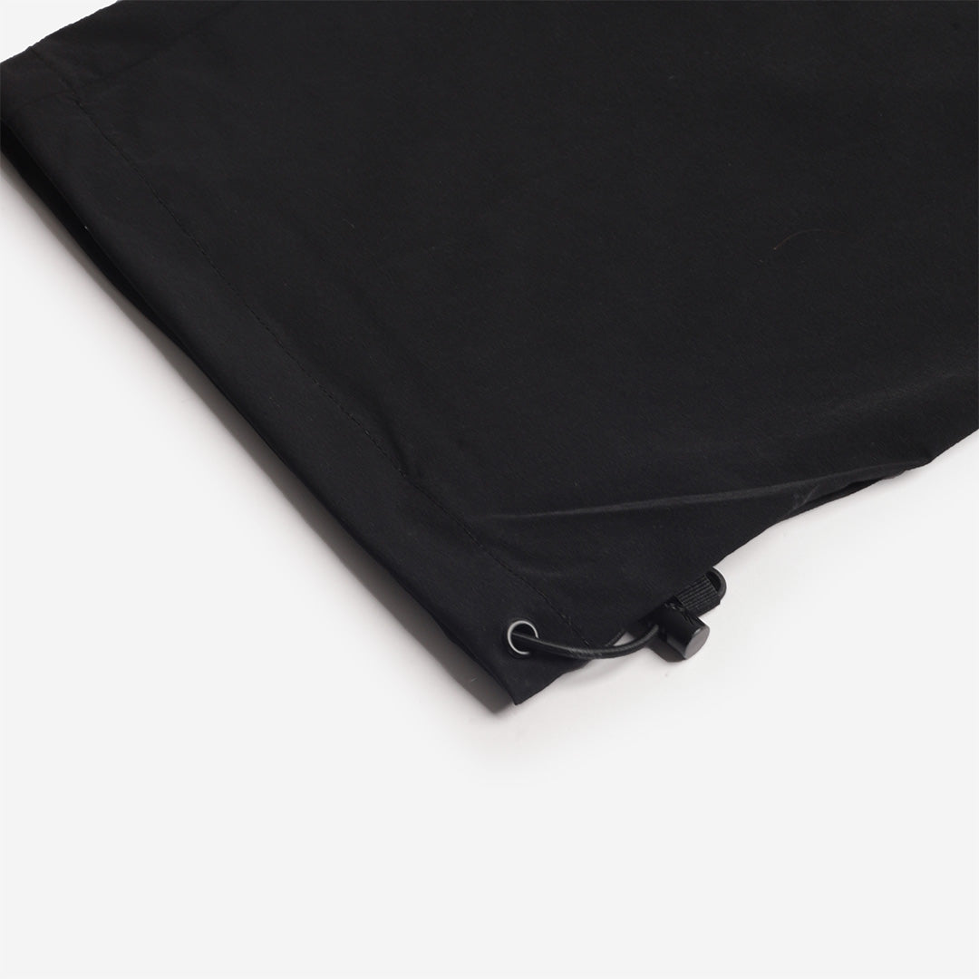 Adjustable drawcord hem on the black trousers