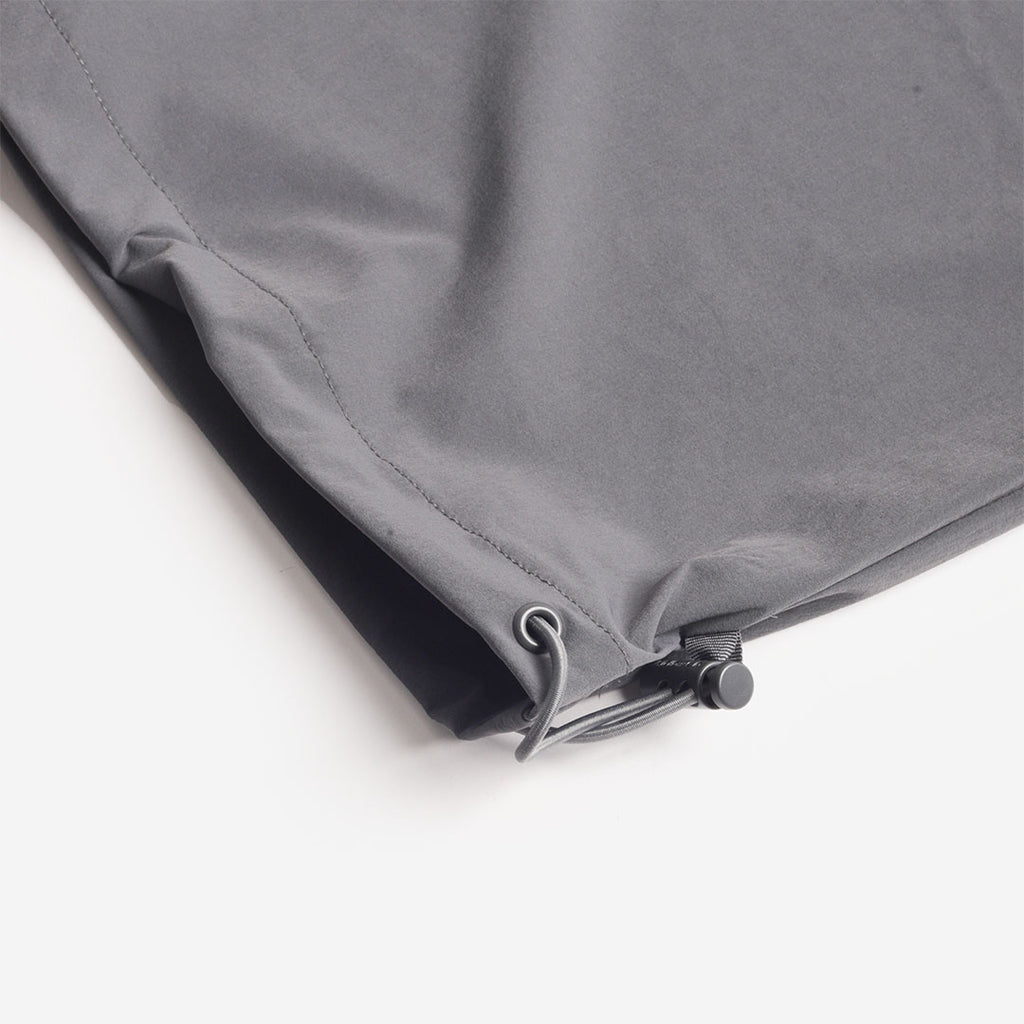 Adjustable drawcord hem on the grey trousers
