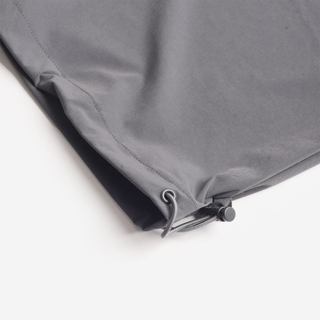 Adjustable drawcord hem on the grey trousers