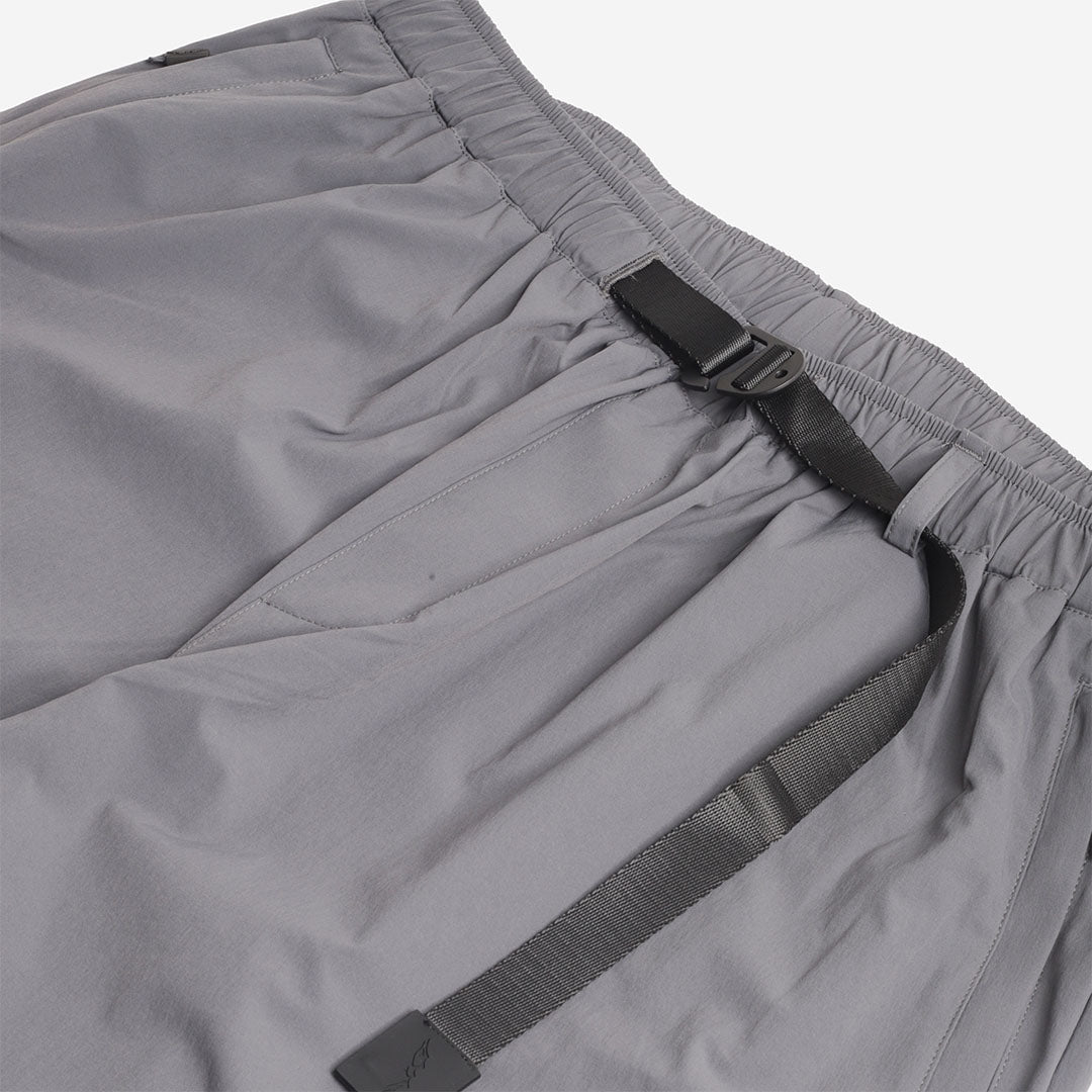 Webbing belt and buckle detail, grey trousers