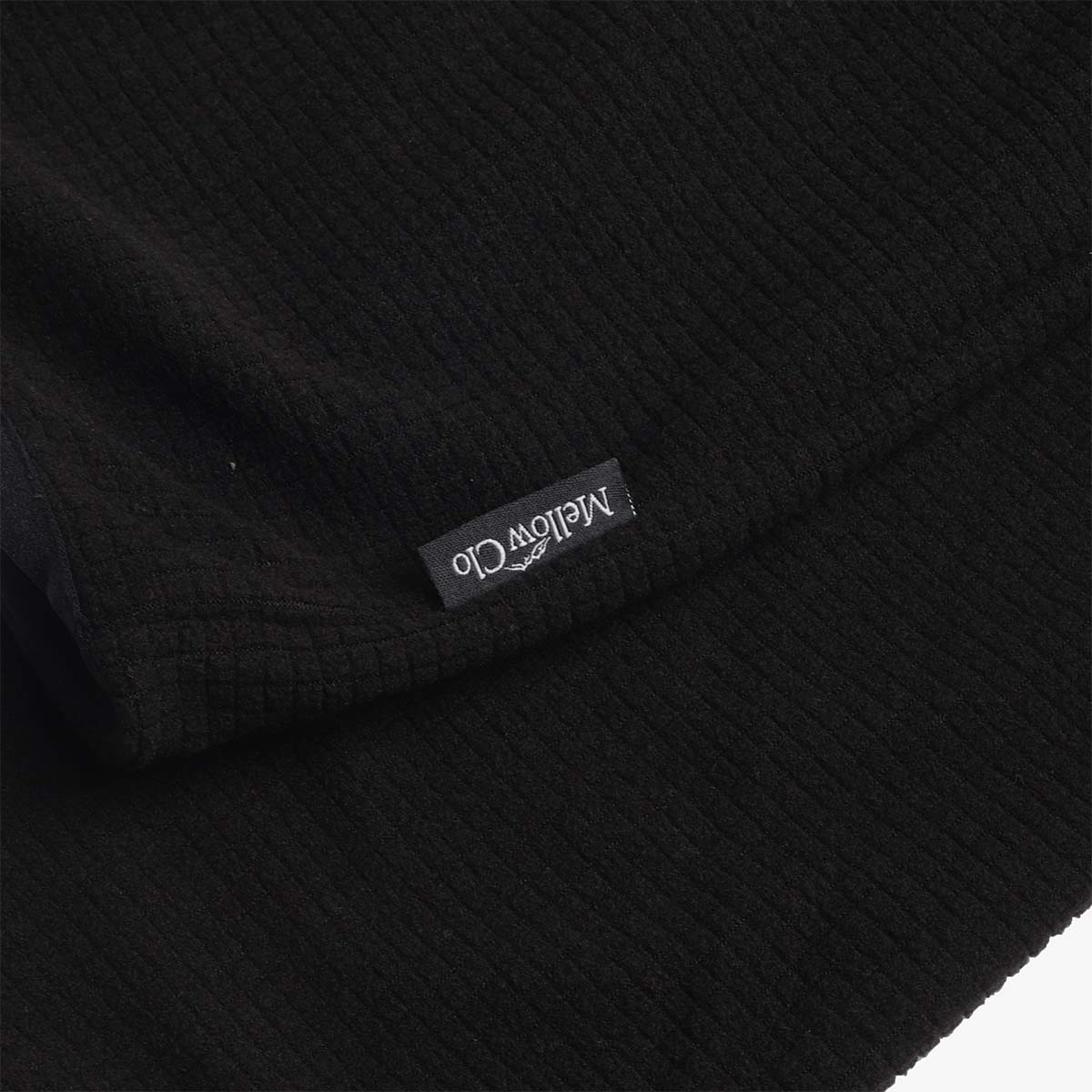 Woven Mellow Clo label on the black fleece cuff
