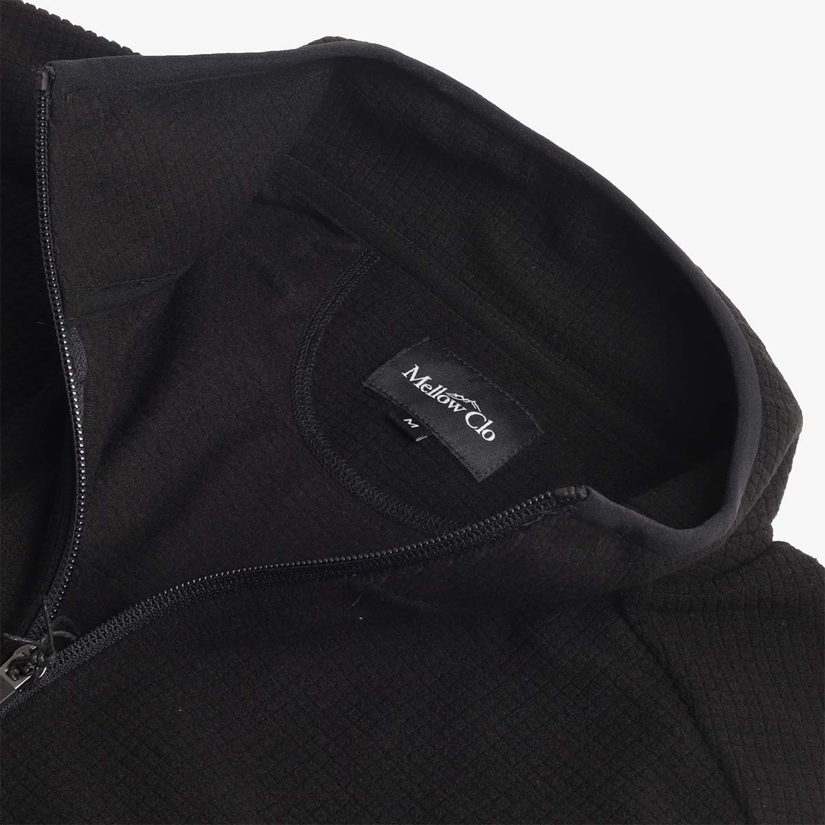 Half zip collar and Mellow Clo label, black grid fleece