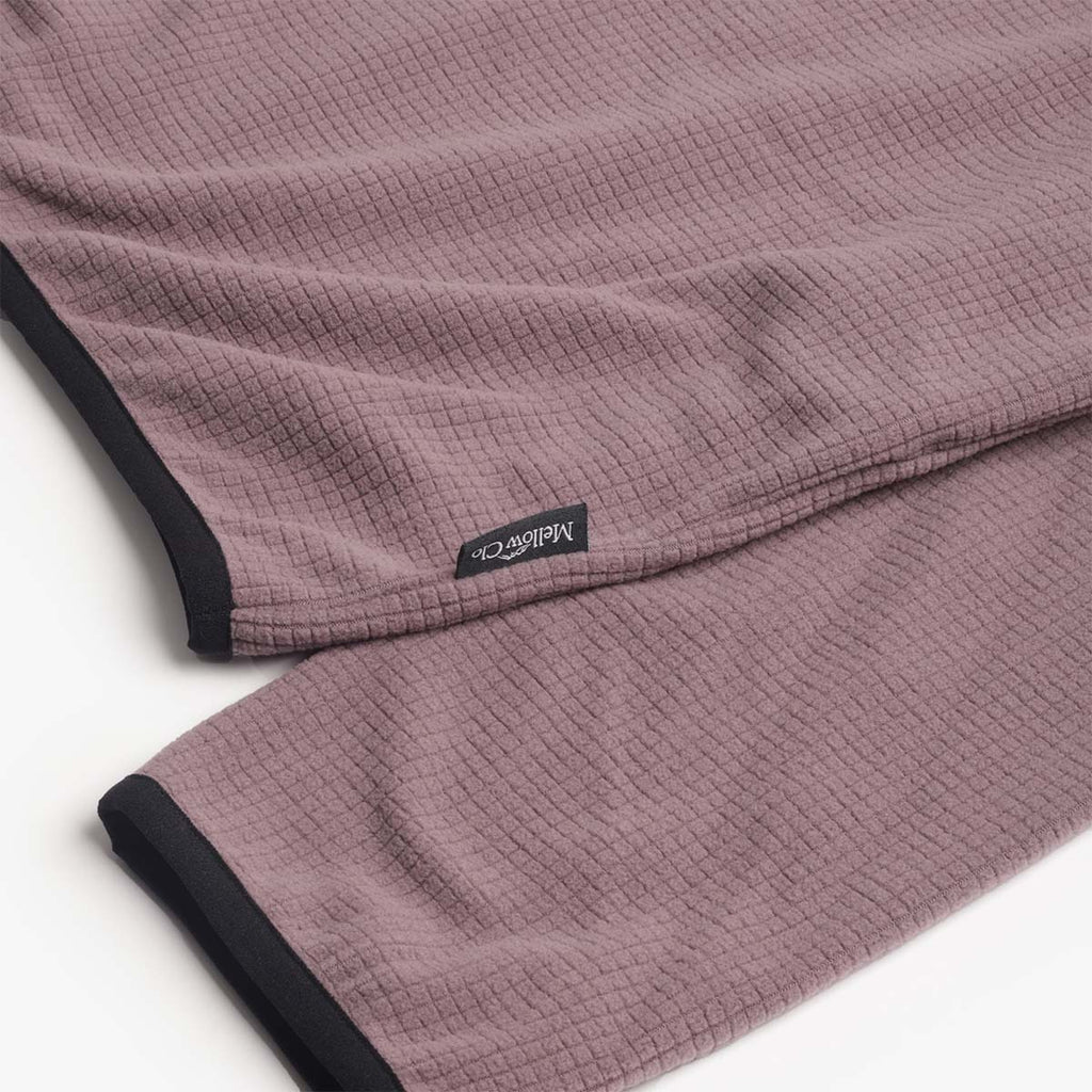 Woven Mellow Clo label on the plum fleece hem
