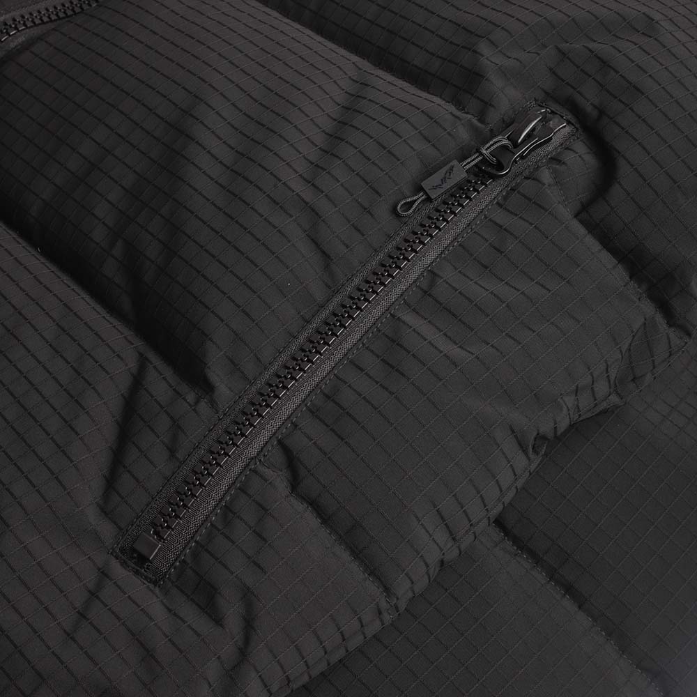 Zipped pocket detail on the black puffer jacket