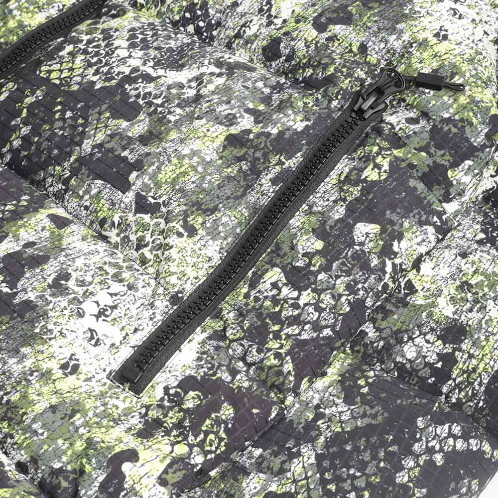 Zipped pocket detail on the serpent camo puffer
