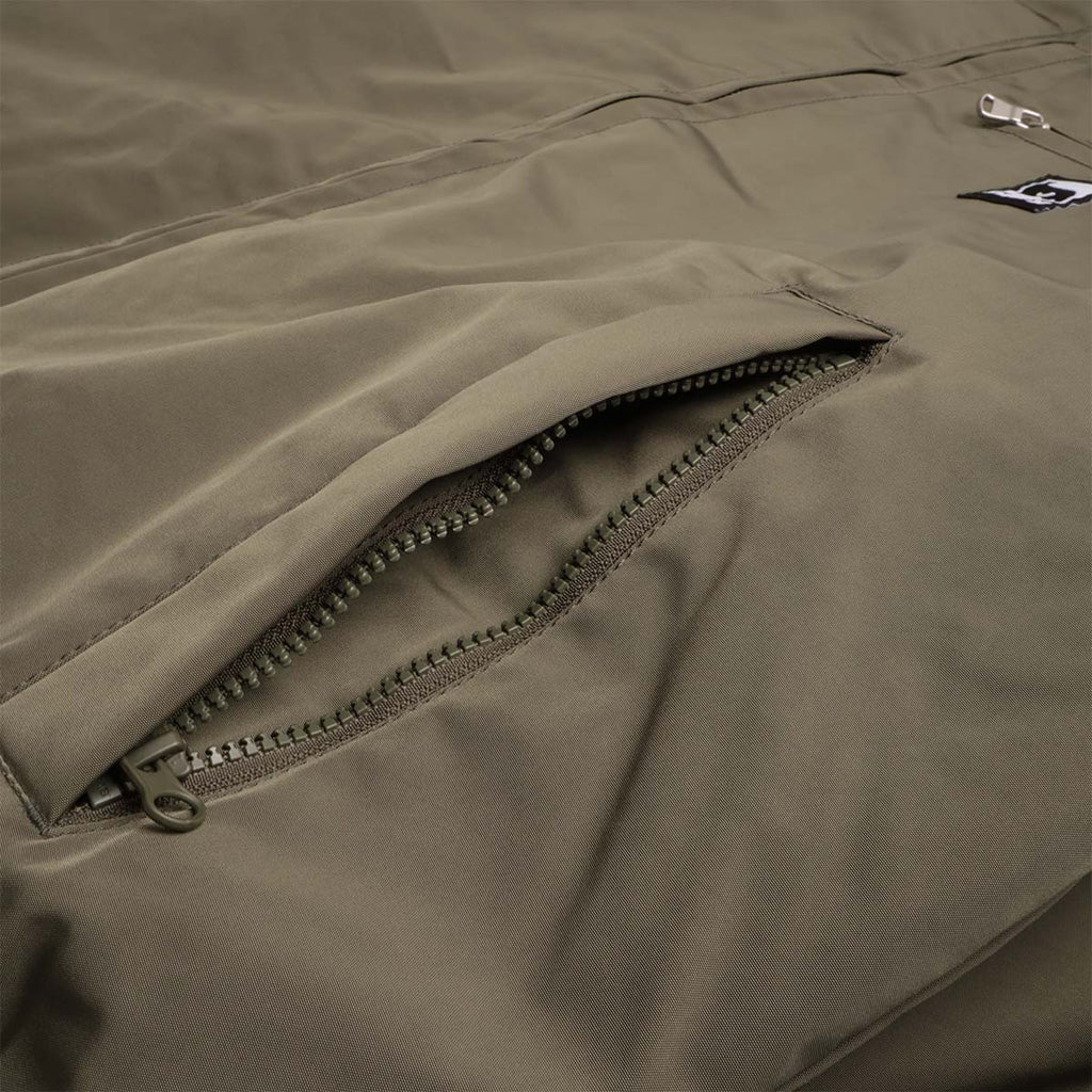 Zip pocket detail on olive Elysian jacket