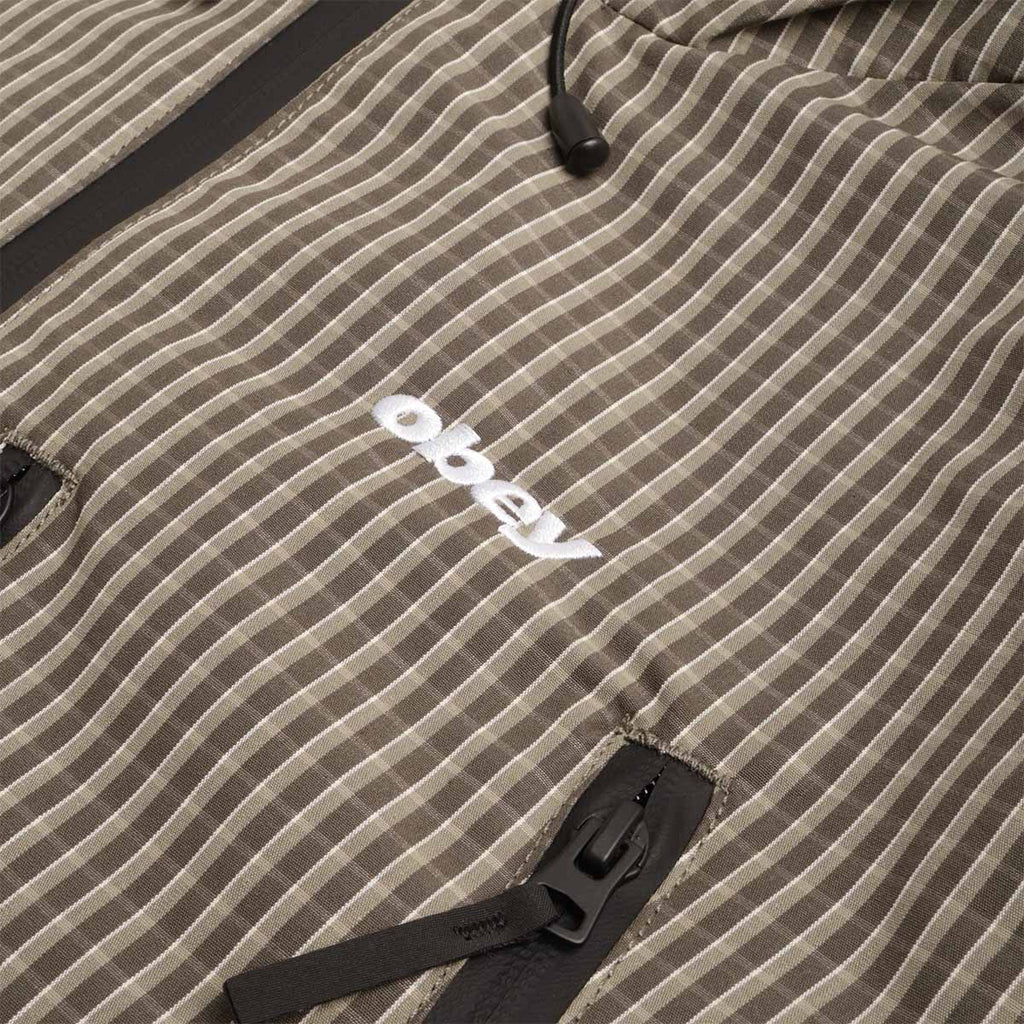 OBEY logo patch on green check fabric