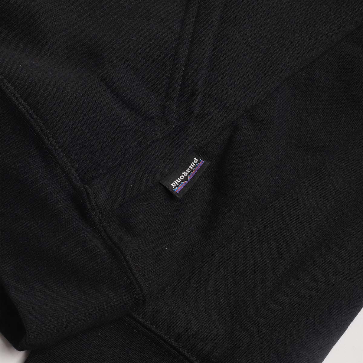 Patagonia hem label on the black Uprisal hoodie