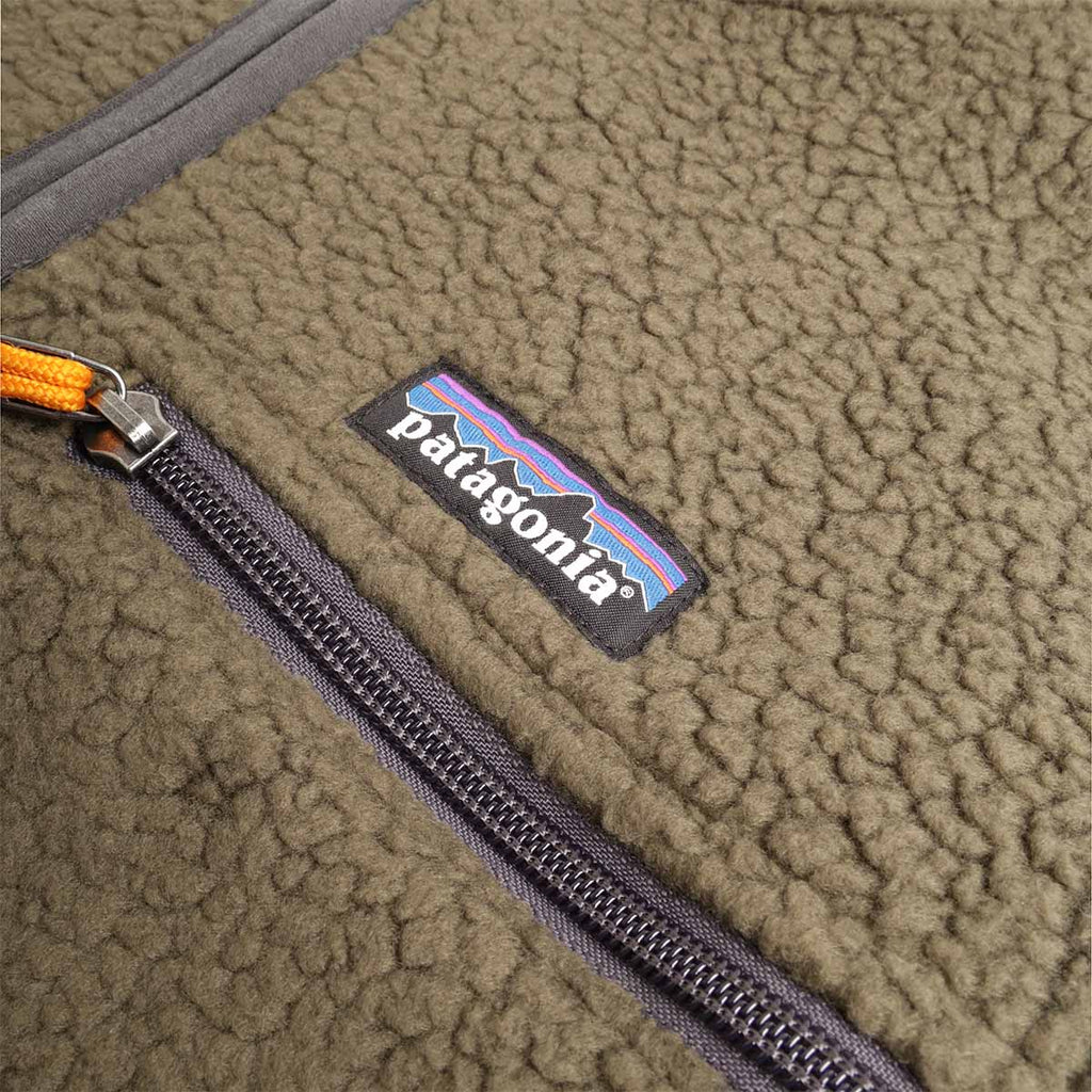 Chest zip pocket with Patagonia label and orange zip pull