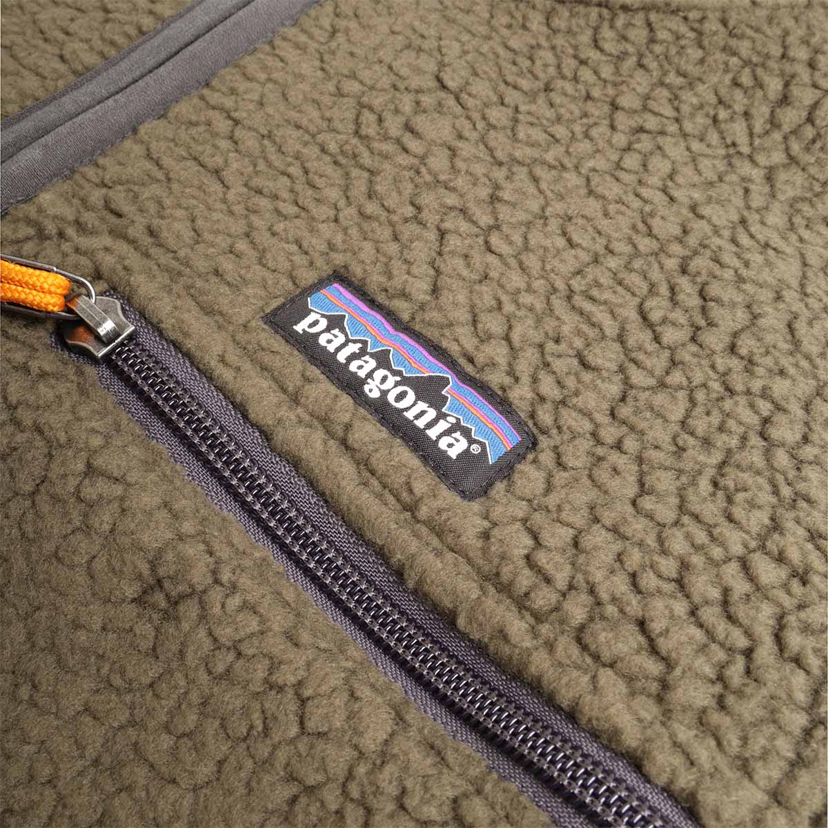 Chest zip pocket with Patagonia label and orange zip pull