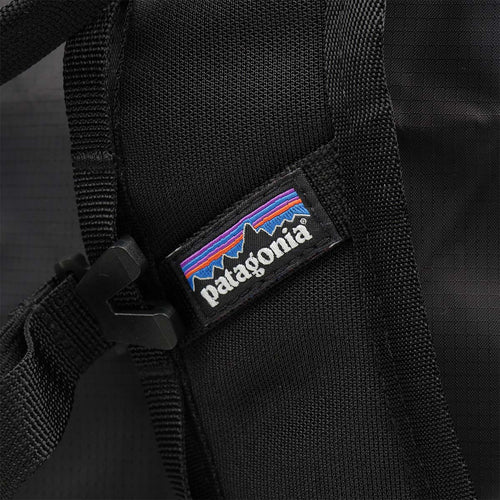 Patagonia woven label on black tote pack strap