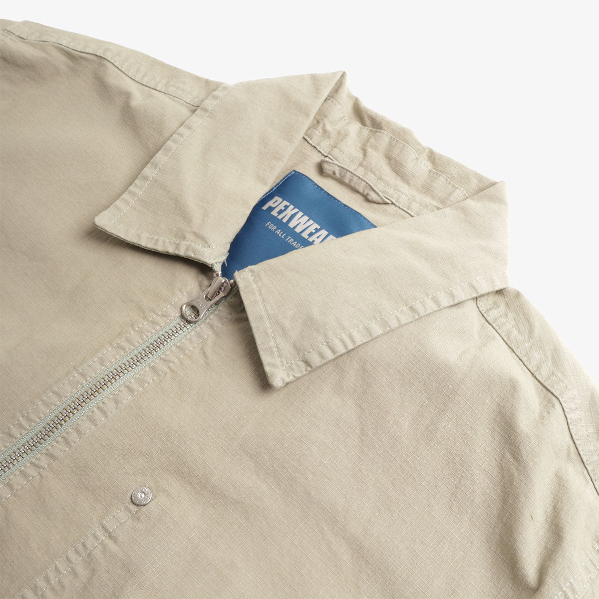 Pexwear Mechanics Jacket in Faun Green Ripstop — close-up of the ripstop cotton fabric weave and stitching