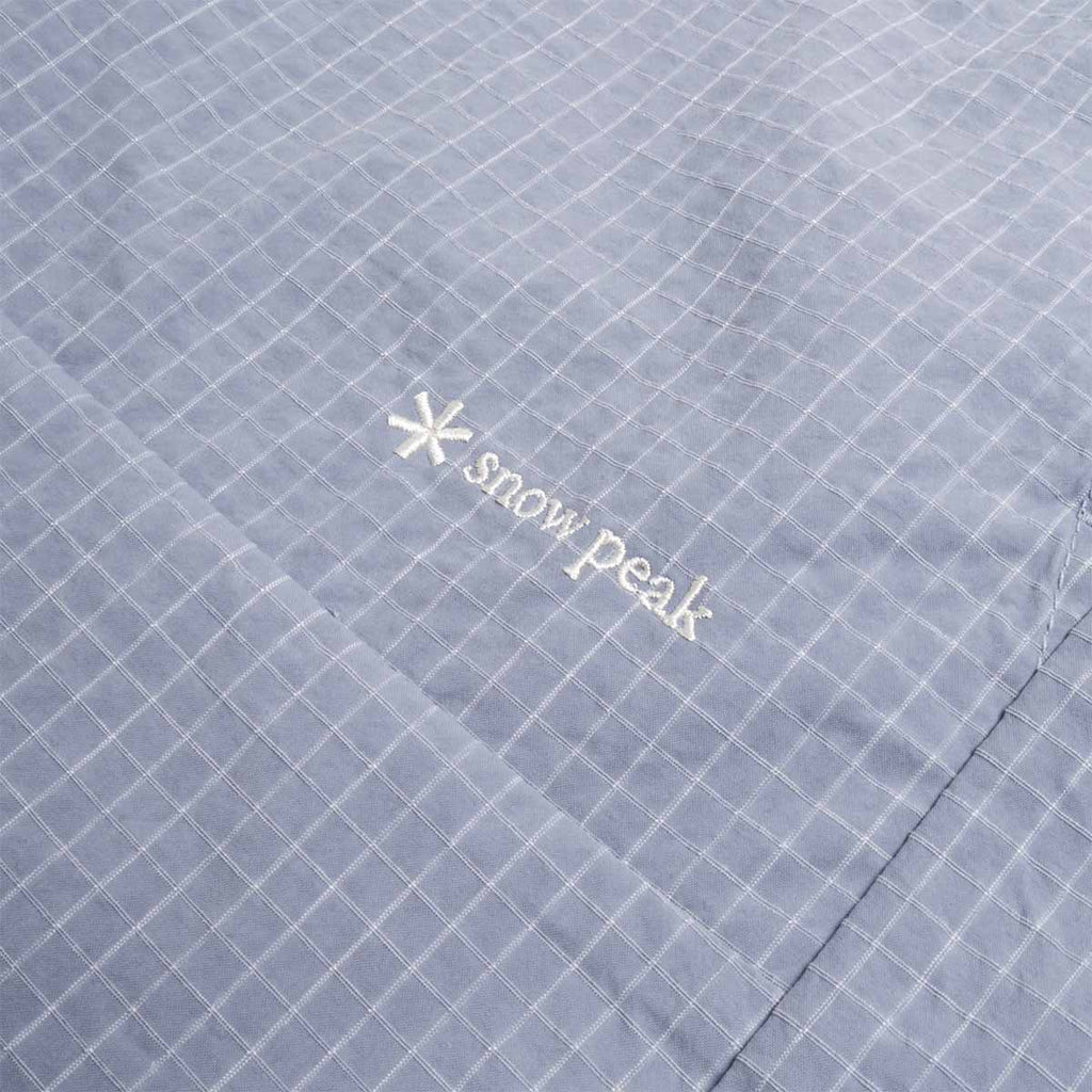 Embroidered Snow Peak logo on light blue kasuri fabric