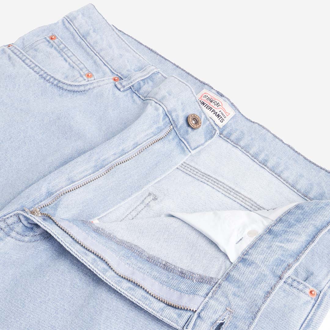 Button fly and slant pocket detail on Stan Ray mid wash jeans