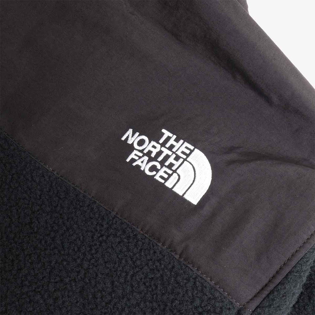 White The North Face logo on black fleece panel