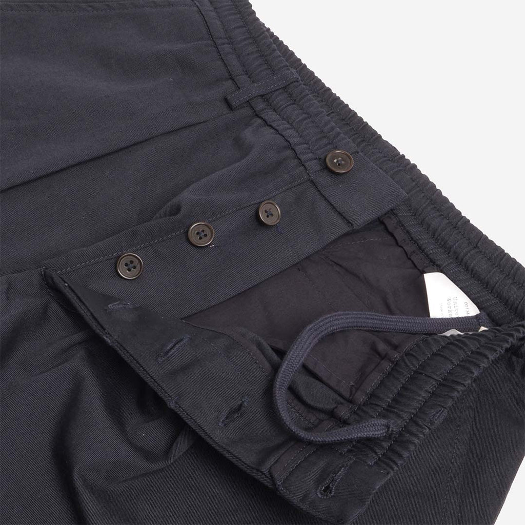 Button fly and inner drawcord on the navy pleated trousers